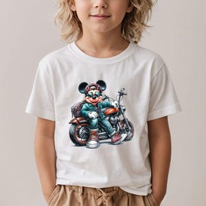 May include: White t-shirt with a cartoon image of Mickey Mouse wearing sunglasses and a hat, riding a motorcycle.