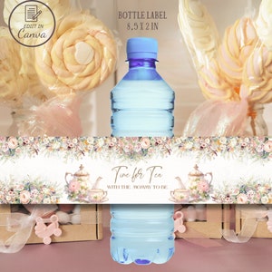 May include: A white bottle label with floral designs and the text "Time for Tea with the Mommy to Be". The label is 8.5 inches by 2 inches.