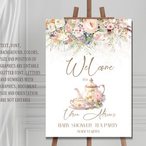 Op de afbeelding: Een wit welkomsbord met een bloemige rand en een illustratie van een theepot en een theekopje. De tekst luidt "Welkom bij Lorna Adrian's Baby Shower Tea Party March 12th".