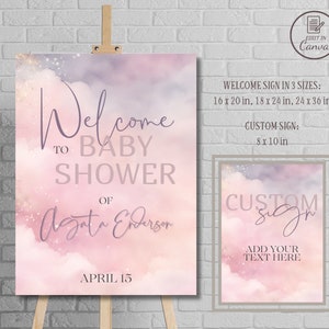 May include: Welcome sign for a baby shower with a pink and purple watercolor background with clouds and glitter. The text reads "Welcome to Baby Shower of Agata Ederson April 15".