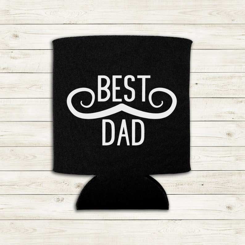 Op de afbeelding: Zwarte blikjeskoeler met een witte snor en de tekst "BEST DAD" erop gedrukt.