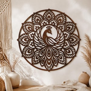 May include: A dark brown, circular wooden wall art piece featuring a peacock design. The peacock is centered within a mandala-style pattern of stylized feathers. The text "Digital Cut Files" is visible in the lower left corner.