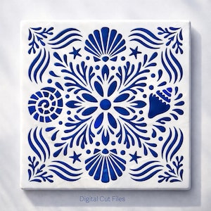 May include: Square white tile with a blue, intricate design featuring seashells, starfish, and floral elements. The design is cut out, revealing a darker blue background. The text "Digital Cut Files" is at the bottom.