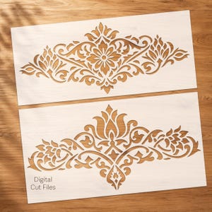 May include: Two decorative stencils with intricate floral and scrollwork designs. The stencils are cut from a light-colored material, revealing a contrasting wood grain background. The text "Digital Cut Files" is visible on the bottom stencil. Ideal for DIY craft projects.