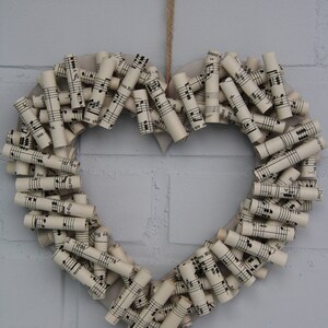 Wall decoration, wall wreath in the shape of a heart, old music paper, upcycling