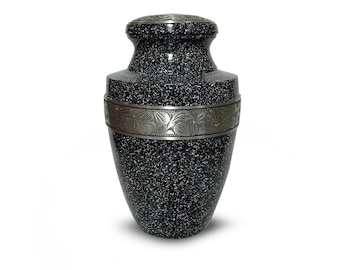 May include: Black and white speckled urn with a silver band and floral design. The urn has a rounded top and a wide base.
