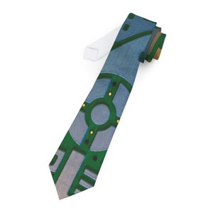 May include: A green and blue patterned tie with a geometric design. The tie has a white lining.