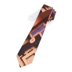May include: A brown and orange tie with a blurred image of a computer keyboard and mouse.