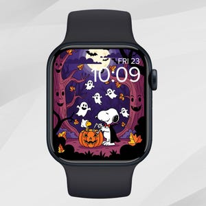 May include: A black smartwatch displaying a Halloween-themed graphic. The screen shows Snoopy in a Halloween scene with ghosts, a pumpkin, and a full moon. The time is 10:09, and the date is Friday, the 23rd.