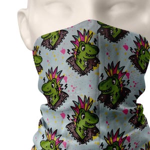 May include: A blue and white face mask with a repeating pattern of green cartoon dinosaurs with pink and yellow mohawks. The dinosaurs are wearing studded collars and have a punk rock aesthetic.