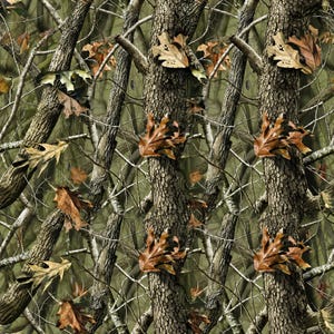 May include: A camouflage pattern featuring a repeating forest scene with textured tree trunks, thin bare branches, and scattered brown oak leaves. The design uses a palette of dark brown, tan, and muted green tones to create a dense woodland effect.