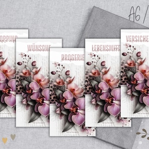 Könnte beinhalten: Eine Sammlung dekorativer Karten mit floralen Designs, die Orchideen in Rosa- und Lilatönen zeigen. Jede Karte trägt ein anderes deutsches Wort wie "Shopping" und "Versicherung". Der Hintergrund enthält einen Leopardenmuster.