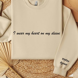 I Wear My Heart On My Sleeve Sweater and Hoodie Custom Mama Sweatshirt with Children Name on Sleeve Gift for Mom