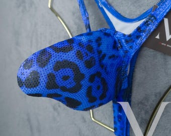 May include: Blue and black leopard print mesh underwear with a white lining. The underwear is hanging on a gold hanger.