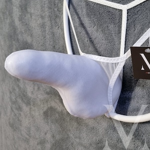 May include: White mesh thong underwear with a pouch. The underwear has a circular design and a tag with the brand name. The pouch is light blue and the thong is white.