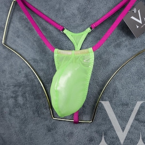 May include: Lime green mesh underwear with pink straps. The underwear is hanging on a gold hanger.