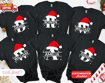 May include: Black t-shirts with a Santa hat design. Each shirt features a letter and a name: Daniel, William, Amelia, and Rowen. The design includes a Christmas tree and stars. Customization is available.