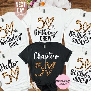 May include: Five white t-shirts with black text and leopard print hearts. The text on the shirts reads "50th Birthday Girl", "50th Birthday Crew", "50th Birthday Squad", "Hello 50", and "50th Birthday Queen".