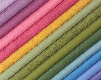 May include: A rainbow assortment of colorful felt strips, arranged in a diagonal pattern. The felt is a soft, textured material.