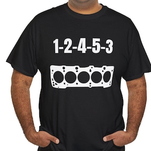 May include: Black t-shirt with white text that reads "1-2-4-5-3" and a white graphic of an engine block.