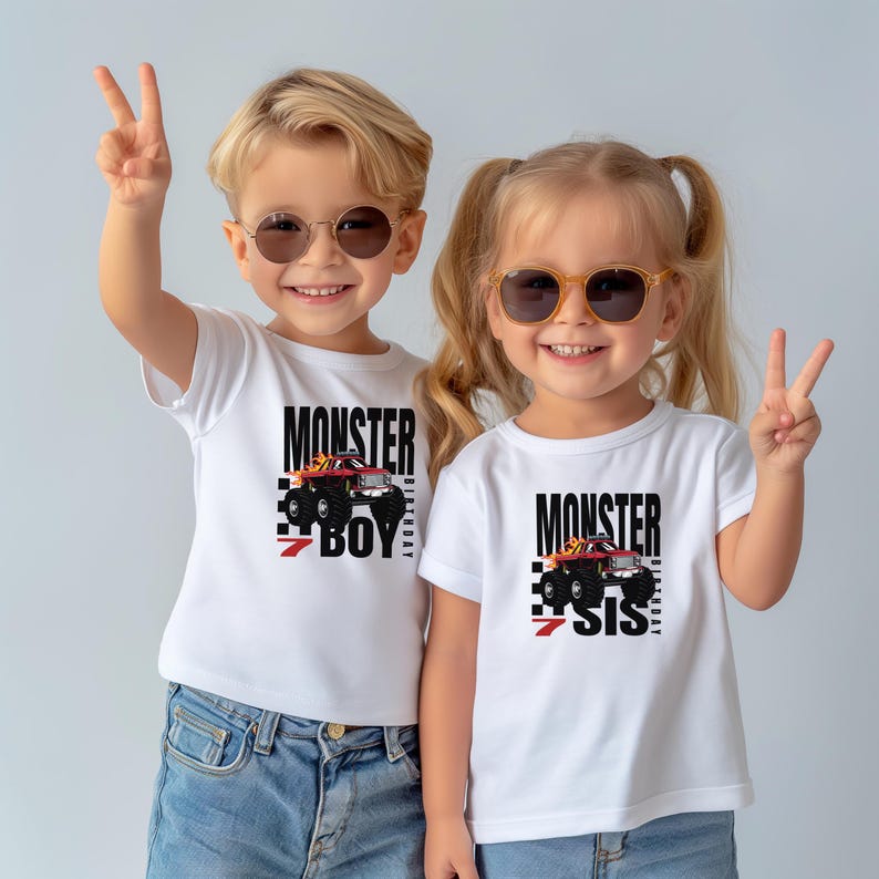 May include: Two children wearing white t-shirts with a monster truck graphic and the text "Monster 7 Boy" and "Monster 7 Sis". The children are wearing sunglasses and smiling.