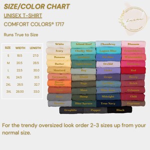 May include: A size and colour chart for unisex t-shirts. The chart shows the width and length measurements in inches for sizes S, M, L, XL, 2XL, and 3XL. The chart also shows a variety of colours, including white, ivory, banana, butter, mustard, terracotta, burnt orange, granite, graphite, pepper, black, island reef, chalky mint, light green, bay, khaki, sage, moss, hemp, blue spruce, chambray, lagoon blue, indigo blue, orchid, violet, grape, blue jean, midnight, true navy, blossom, crunchberry, watermelon, red, berry, brick, crimson, chili, and espresso.