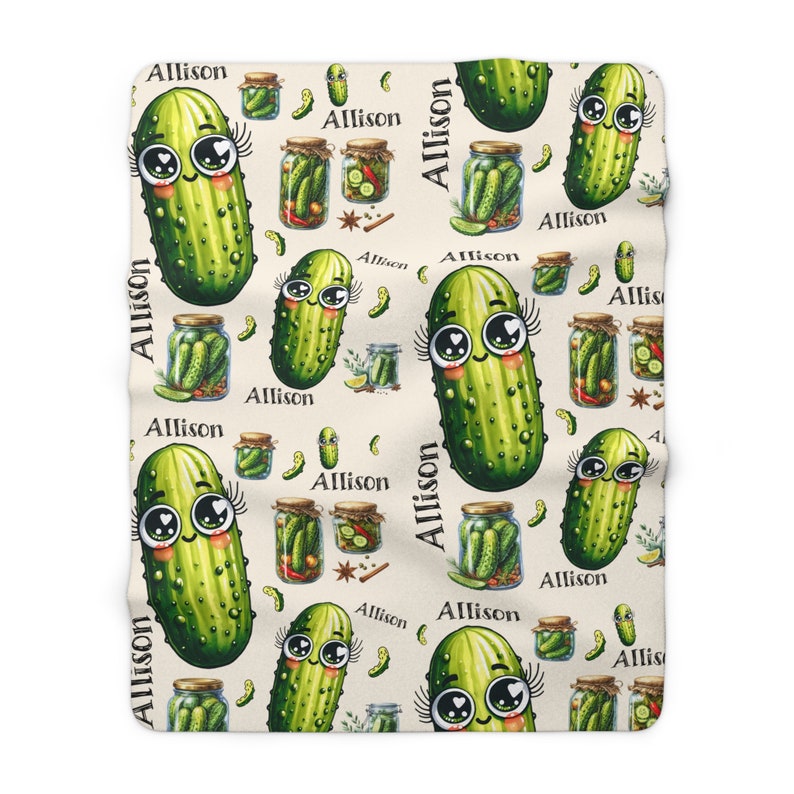 May include: A cream-colored fabric with a repeating pattern of green cartoon pickles with eyelashes and hearts. The pickles are in jars with dill, spices, and other pickling ingredients. The text "Allison" is repeated throughout the pattern.