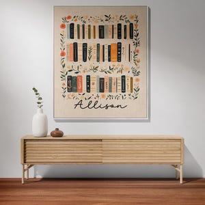 May include: A beige canvas print with a floral border and a bookshelf filled with books. The name "Allison" is written in black cursive at the bottom of the print.