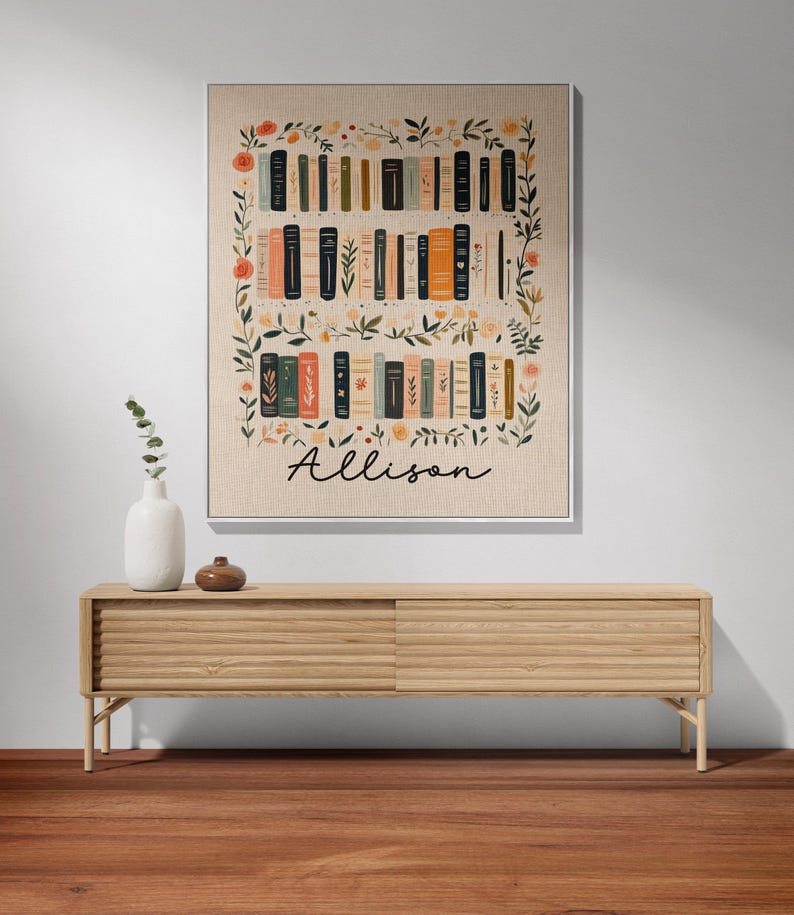May include: A beige canvas print with a floral border and a bookshelf filled with books. The name "Allison" is written in black cursive at the bottom of the print.