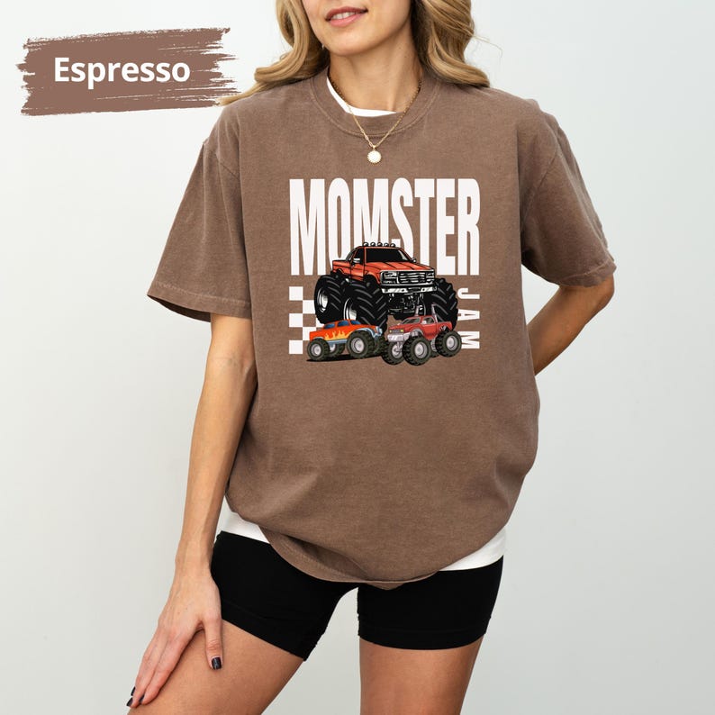 May include: Espresso brown t-shirt with a white graphic of a monster truck and the text "MOMSTER JAM".