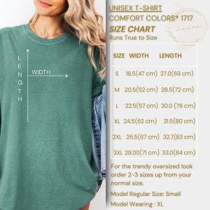 May include: Unisex t-shirt size chart with measurements in inches and centimetres. The chart shows the width and length of the shirt in different sizes, from small to 3XL. The chart also includes a note that the shirt runs true to size and that for a trendy oversized look, order 2-3 sizes up from your normal size. The model is wearing a size XL.