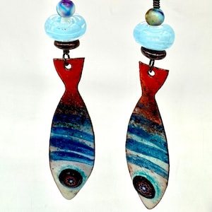 Long blue red enameled copper fish charm earrings with blue swirl lamp work bead colorful quartz and purple Czech glass rondelle bead accent