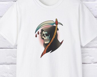 May include: White t-shirt featuring a Grim Reaper design. The graphic depicts a skull with a black hood, holding a scythe with a blue blade and gold handle. Red teardrops are visible. The design is in a traditional tattoo style.