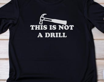 May include: Black t-shirt with a white hammer graphic and the text "This is not a drill".