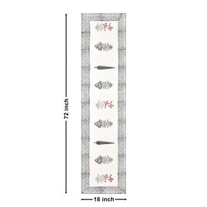 May include: White table runner with a gray border and a repeating pattern of black and red floral designs. The runner is 72 inches long and 18 inches wide.