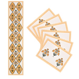 May include: Set of six yellow and white floral placemats with a matching yellow and white table runner. The placemats have a yellow border with a white stripe pattern. The table runner has a repeating floral pattern.
