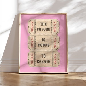 May include: A framed print with a pink background and three vintage ticket stubs. The tickets have the text "The Future Is Yours To Create" printed on them.