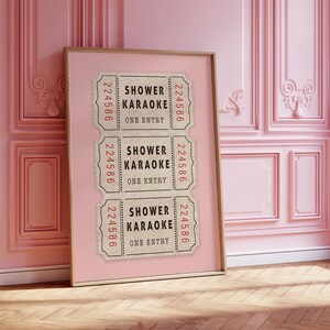 May include: Three vintage-style tickets with the text "Shower Karaoke" and the number "224586" printed on each. The tickets are displayed on a pink background.