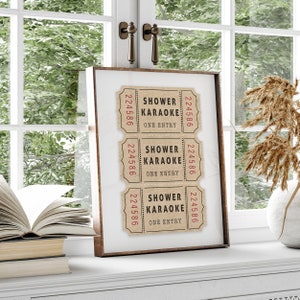 May include: A framed print with three vintage-style tickets that say "Shower Karaoke" with the number "224586" on each ticket.