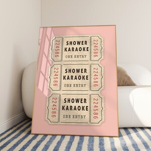 May include: Three vintage-style tickets with the text "Shower Karaoke" and the number "224586" printed on each. The tickets are displayed on a pink background.