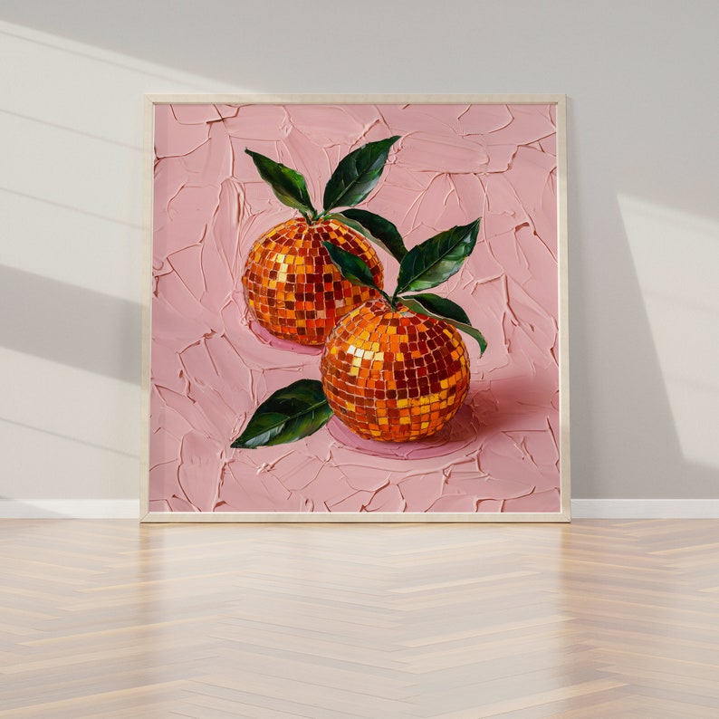 A framed oil painting of two vibrant oranges with a disco ball mosaic pattern, set against a textured pink background. The artwork exudes modern flair and vintage charm, perfect for kitchen or dining room decor.