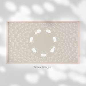 May include: A framed print with a beige background and a white design of a circle of figures. The figures are stylized and resemble people. The text "WONY WONDER" is printed below the image.