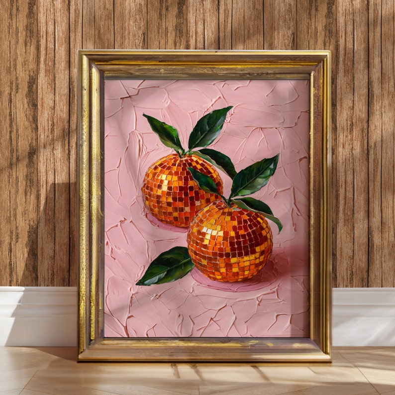 A framed oil painting of two vibrant oranges with a disco ball mosaic pattern, set against a textured pink background. The artwork exudes modern flair and vintage charm, perfect for kitchen or dining room decor.