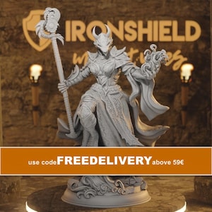 May include: A grey, unpainted resin miniature figurine of a horned, dragon-like humanoid character standing on a circular base. The figure wears ornate armour, holds a tall, intricate staff in one hand, and displays swirling magical energy in the other.