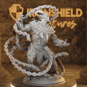 May include: A detailed, gray figurine of a horned creature with chain-like appendages. The figure is posed dynamically, with arms outstretched and chains swirling around it. The base is round, and the background features the text "IRONSHIELD Adventures".