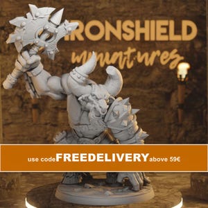 May include: A grey miniature figure of a horned minotaur warrior standing on a circular base. The figure holds a large, spiked circular axe in one raised hand and wears spiked shoulder armor. The background features the text IRONSHIELD miniatures.
