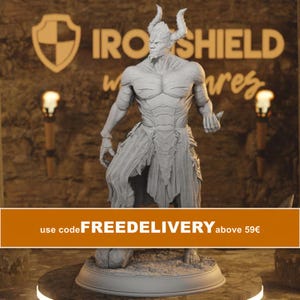 May include: A light grey, unpainted resin miniature figure of a horned demon standing on a circular base. The figure features a muscular build, a goatee, and a textured loincloth. The background displays the text IRONSHIELD and a shield logo.