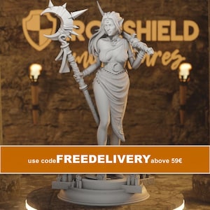 May include: A light gray resin miniature figurine of a female elf character standing on a circular base. The figure holds a tall staff topped with a crescent moon and wears a draped garment with a moon emblem on the belt and a necklace.