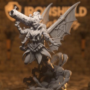 May include: A grey 3D printed figurine of a female fairy with wings, holding a large steampunk-style gun. The fairy is wearing a leather jacket, a skirt, and boots. The figurine is standing on a cloud-like base.