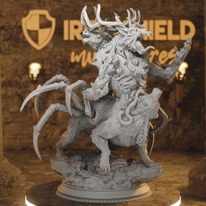 May include: A detailed grey fantasy sculpture of a creature with deer antlers, a spider-like body, and a wolf-like lower body. The sculpture has intricate details and is set against a blurred background with the text "IRON SHIELD miniatures".